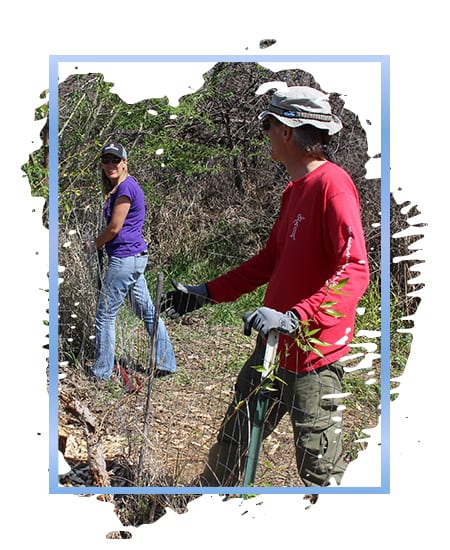 2 people working on a fence